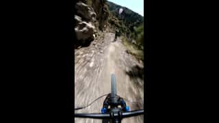 First-person POV downhill cycling video, extreme steep slope, rapid accelerat...