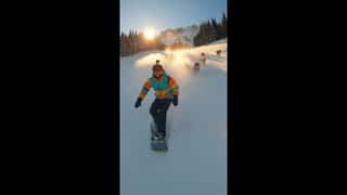 Sunny winter day in the French Alps, steep snowy slope with fresh powder, pin...
