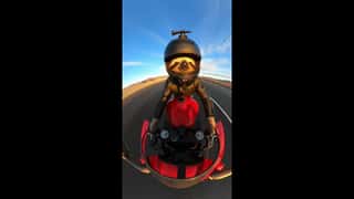 [00:00-00:01] The camera is mounted on the handlebars of a motorcycle, lookin...