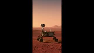 Modern robotic rover moving slowly across Martian terrain, drilling into rock...